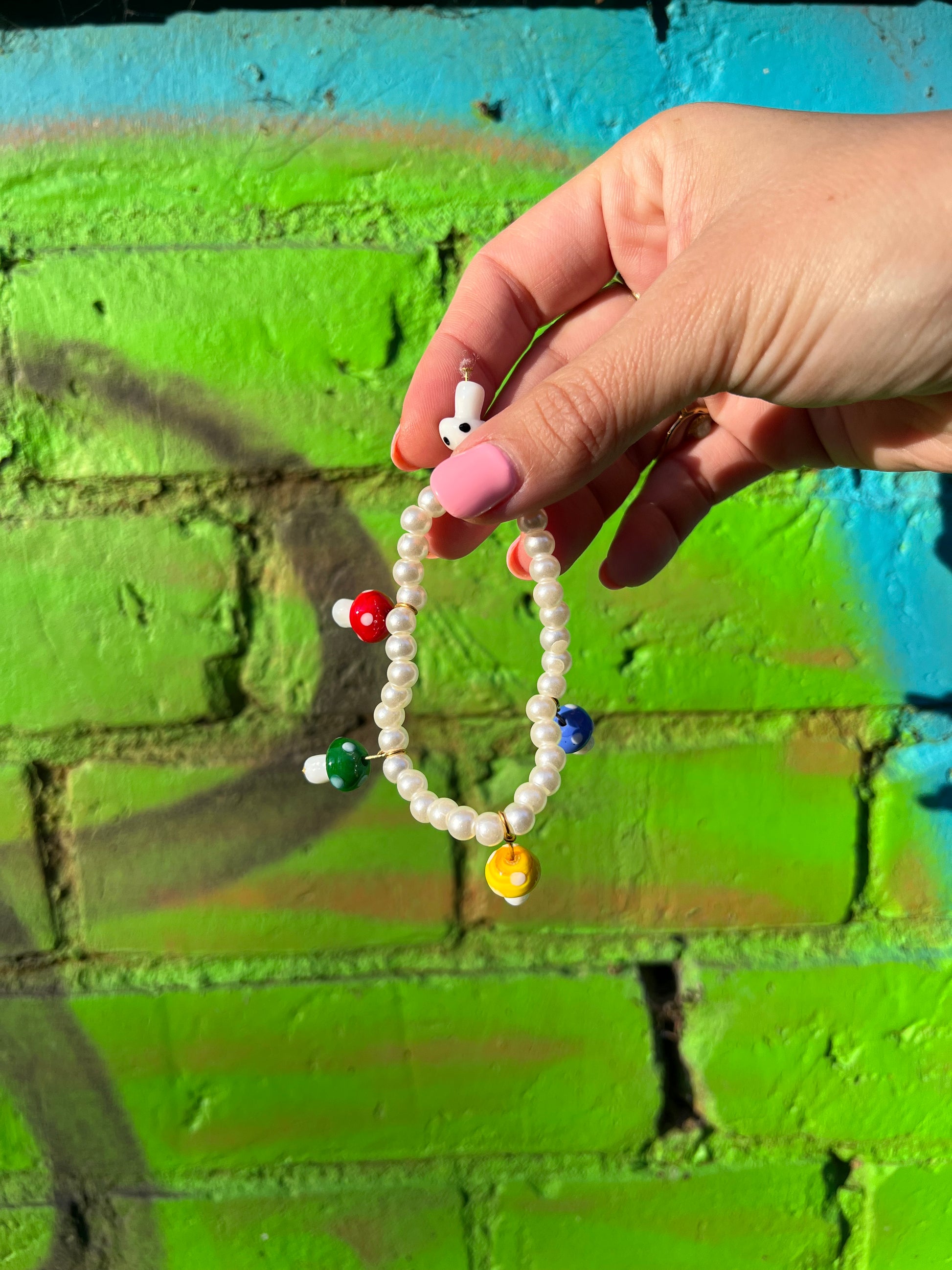 Handmade bracelet featuring white fantasy pearls and multicolored crystal mushroom beads."