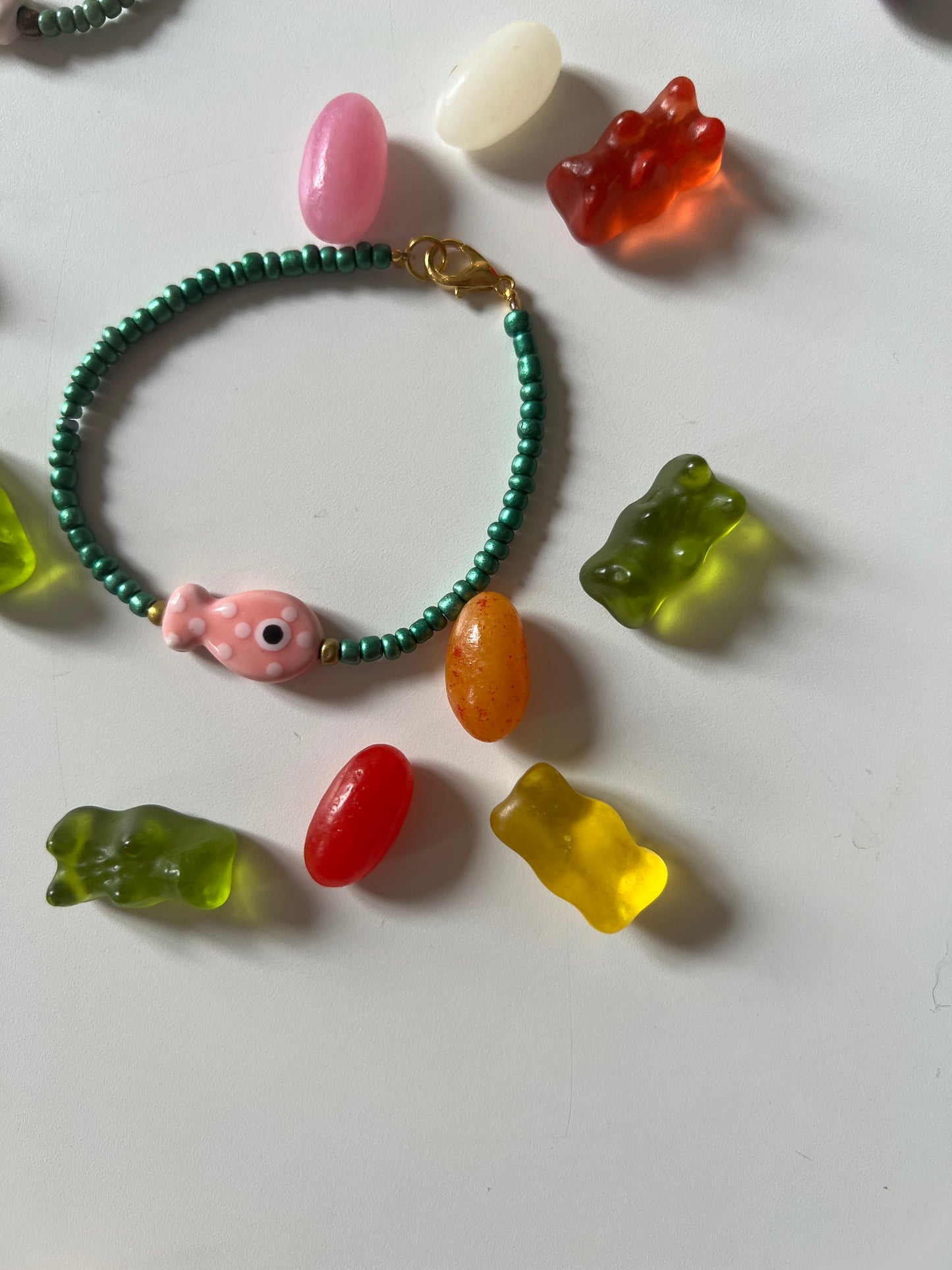 Bird's Eye View of Bracelets . Featuring Ceramic Fish Beads in pink fish and green beads